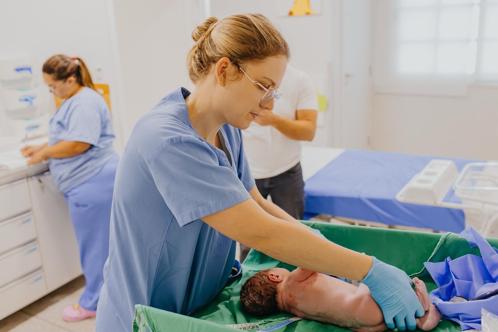 Dra. Camila prestando assistência a um recém-nascido na sala de parto